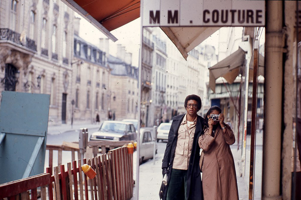 Paris street with photographer and Arthur Ashe in reflection